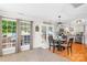 Bright dining area adjacent to kitchen features wood floors and backyard access at 8020 Sheckler Ln, Matthews, NC 28104