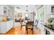 Open-concept dining area flows into the living room, showcasing hardwood floors and natural light at 8020 Sheckler Ln, Matthews, NC 28104