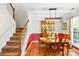 Charming dining room with traditional furnishings, hardwood floors, and staircase access at 8020 Sheckler Ln, Matthews, NC 28104