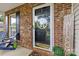 Welcoming front porch featuring brick accents and a decorative front door at 8020 Sheckler Ln, Matthews, NC 28104