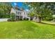 Traditional home with a beautiful lawn and mature trees, perfect for outdoor enjoyment and curb appeal at 8020 Sheckler Ln, Matthews, NC 28104