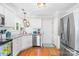 Kitchen features stainless steel appliances, white cabinetry, granite countertops, and modern lighting at 8020 Sheckler Ln, Matthews, NC 28104