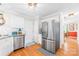 Kitchen featuring stainless steel appliances, white cabinetry, granite countertops, and hardwood flooring at 8020 Sheckler Ln, Matthews, NC 28104