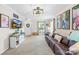 Inviting living room with ample natural light, a comfortable leather sofa, and a large television at 8020 Sheckler Ln, Matthews, NC 28104