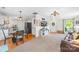 Open-concept living area blending modern living with dining, featuring a comfortable sofa and stylish decor at 8020 Sheckler Ln, Matthews, NC 28104