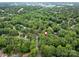 Overhead view of a wooded residential area, with a marker showing property location at 8201 Lansford Rd, Charlotte, NC 28277