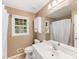 Bathroom featuring a vanity, toilet, and combination shower and tub; complemented by natural light at 8201 Lansford Rd, Charlotte, NC 28277