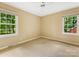 Well-lit bedroom with carpet and large windows, creating a comfortable and inviting space at 8201 Lansford Rd, Charlotte, NC 28277