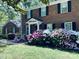 Charming brick home with colorful azaleas adding a touch of vibrancy to the landscaped front yard at 8201 Lansford Rd, Charlotte, NC 28277