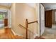 Upstairs hallway featuring wood floors, and multiple doorways to rooms in the home's upper level at 8201 Lansford Rd, Charlotte, NC 28277