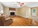 Cozy living room with brick fireplace and hardwood floors at 8201 Lansford Rd, Charlotte, NC 28277