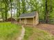 Outdoor storage building in private backyard setting, creating the perfect outdoor living and storage space at 8201 Lansford Rd, Charlotte, NC 28277