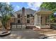 Scenic backyard showcasing a deck, screened porch, patio, and lush landscaping at 9219 Whispering Wind Dr, Charlotte, NC 28277