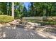 Professionally landscaped backyard with a pond and circular stone paved patio at 9219 Whispering Wind Dr, Charlotte, NC 28277