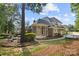 Expansive backyard view highlighting the patio, screened porch, and mature trees at 9219 Whispering Wind Dr, Charlotte, NC 28277