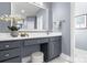 Bathroom vanity with grey cabinets, white countertop, and decorative mirror at 9219 Whispering Wind Dr, Charlotte, NC 28277