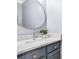 Bathroom featuring a modern vanity, round mirror, stylish faucet, and granite countertop at 9219 Whispering Wind Dr, Charlotte, NC 28277