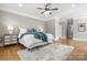 Bright bedroom with a ceiling fan, hardwood floors, and inviting decor at 9219 Whispering Wind Dr, Charlotte, NC 28277