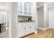 Butler's pantry with granite countertops, white cabinets, and stylish storage solutions at 9219 Whispering Wind Dr, Charlotte, NC 28277