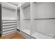 Spacious walk-in closet with wood floors and custom shelving at 9219 Whispering Wind Dr, Charlotte, NC 28277