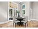 Dining area boasts large windows, wood floors, and elegant decor at 9219 Whispering Wind Dr, Charlotte, NC 28277