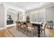 Bright dining room with a black table, seating for six, hardwood floors and natural lighting at 9219 Whispering Wind Dr, Charlotte, NC 28277