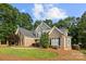 Lovely two-story brick home with a well-manicured lawn and mature trees at 9219 Whispering Wind Dr, Charlotte, NC 28277