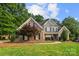 Attractive two-story home with a brick facade, complemented by a lush green lawn at 9219 Whispering Wind Dr, Charlotte, NC 28277