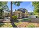 Brick home exterior with a screened-in porch, water feature, and fenced yard at 9219 Whispering Wind Dr, Charlotte, NC 28277
