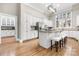 Bright kitchen featuring white cabinets, a center island with seating, and stainless steel appliances at 9219 Whispering Wind Dr, Charlotte, NC 28277