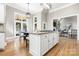 Spacious kitchen features a central island with a granite countertop and seating, perfect for entertaining at 9219 Whispering Wind Dr, Charlotte, NC 28277