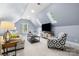 Bright bonus room with vaulted ceilings, sky lights, and cozy seating area at 9219 Whispering Wind Dr, Charlotte, NC 28277