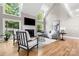 Bright living room featuring high ceilings, a fireplace, and lots of natural light at 9219 Whispering Wind Dr, Charlotte, NC 28277