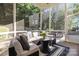 Relaxing screened porch with cushioned seating overlooking the backyard at 9219 Whispering Wind Dr, Charlotte, NC 28277