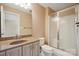 Full bathroom with a single vanity and tiled tub with shower, with glass doors at 100 Woodwinds Dr, Mount Holly, NC 28120