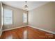 Cozy bedroom with hardwood floors, shuttered windows providing ample natural light at 100 Woodwinds Dr, Mount Holly, NC 28120