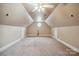 A large bonus room with carpet, a ceiling fan, and a unique circular window at 100 Woodwinds Dr, Mount Holly, NC 28120