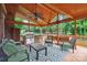 Inviting covered deck with outdoor seating, ceiling fan, and a built-in grill for entertaining guests at 100 Woodwinds Dr, Mount Holly, NC 28120