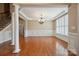 Formal dining area featuring hardwood floors, decorative molding, and a stylish chandelier at 100 Woodwinds Dr, Mount Holly, NC 28120