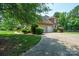A brick home with a long driveway leading to an attached two-car garage at 100 Woodwinds Dr, Mount Holly, NC 28120