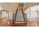 Grand foyer with hardwood floors and staircase featuring detailed wrought iron spindles at 100 Woodwinds Dr, Mount Holly, NC 28120