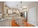 Charming kitchen with custom cabinets, stainless steel appliances, and granite countertops at 100 Woodwinds Dr, Mount Holly, NC 28120