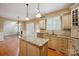 Kitchen area view showcasing custom cabinets, a functional island, and a view to the living room at 100 Woodwinds Dr, Mount Holly, NC 28120