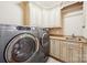 Laundry room featuring front load washer and dryer, built-in cabinets, sink, and laminate countertops at 100 Woodwinds Dr, Mount Holly, NC 28120