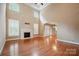 Spacious living area featuring hardwood floors, a fireplace, and high ceilings at 100 Woodwinds Dr, Mount Holly, NC 28120
