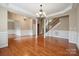 Open living space with hardwood floors, staircase, and decorative columns at 100 Woodwinds Dr, Mount Holly, NC 28120