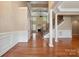 Elegant living area with hardwood floors, fireplace, and staircase with wrought iron spindles at 100 Woodwinds Dr, Mount Holly, NC 28120