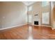 Bright living room with a fireplace, tall ceilings, and large windows providing natural light at 100 Woodwinds Dr, Mount Holly, NC 28120
