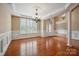 Spacious living area featuring hardwood floors, natural light, and elegant molding at 100 Woodwinds Dr, Mount Holly, NC 28120