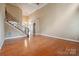 Spacious living room with hardwood floors and staircase leading to upper levels of the home at 100 Woodwinds Dr, Mount Holly, NC 28120